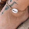 Handmade brass droplet cowrie anklet with recycled shells and brass beads on waxed cord