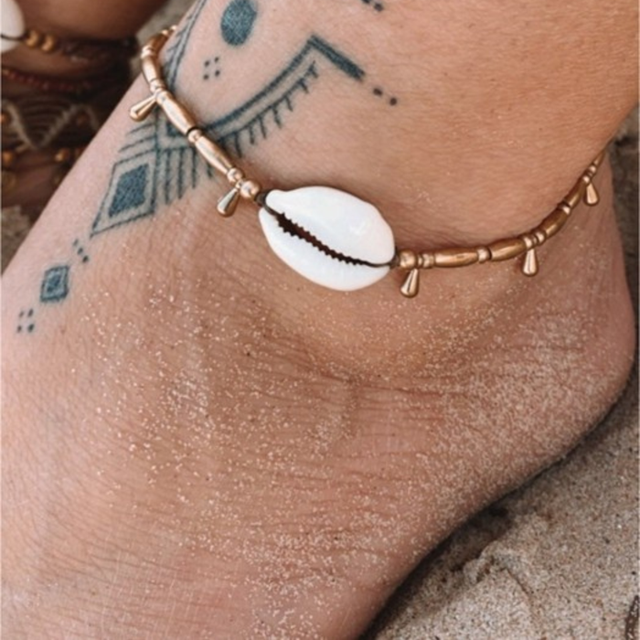 Handmade brass droplet cowrie anklet with recycled shells and brass beads on waxed cord