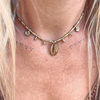 Handmade cowrie brass beaded necklace with natural shells and brass charms on waxed cord