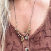 Cowrie brass beaded necklace styled on model showing versatile bohemian coastal jewelry