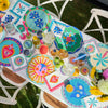 Brighten your table with this 6-piece Fiesta coaster set! Heat-resistant, cork-backed & easy to clean—perfect for coastal homes & gifting.