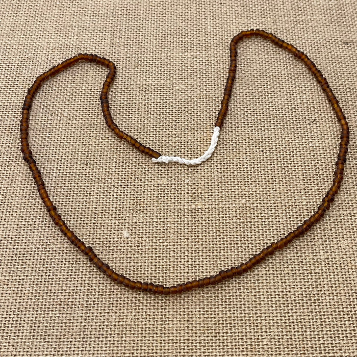Brown rustic string of beads necklace showing natural variations, earthy coastal style