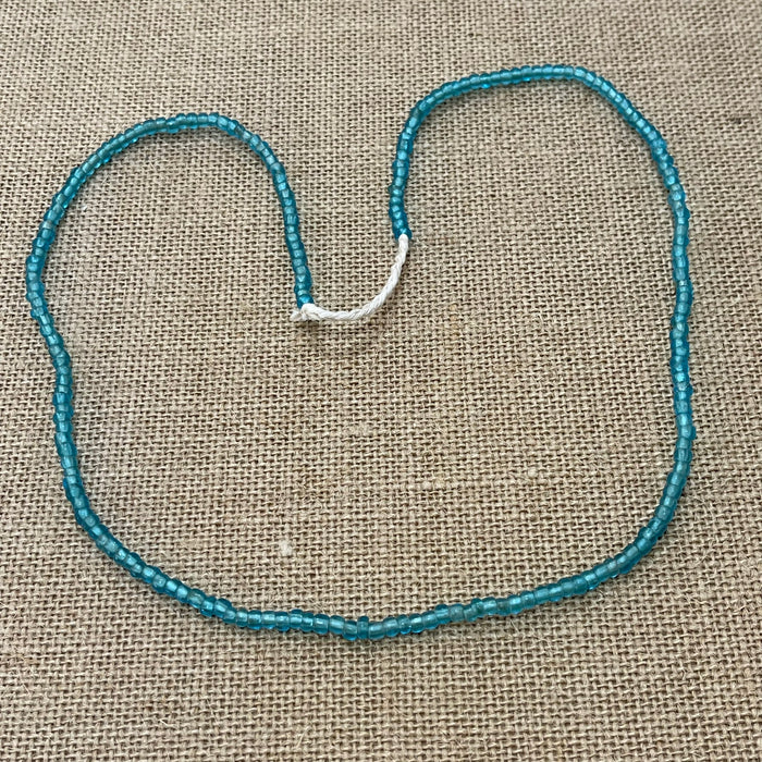 Raw string of beads necklace in blue showing rustic natural texture, coastal accessory