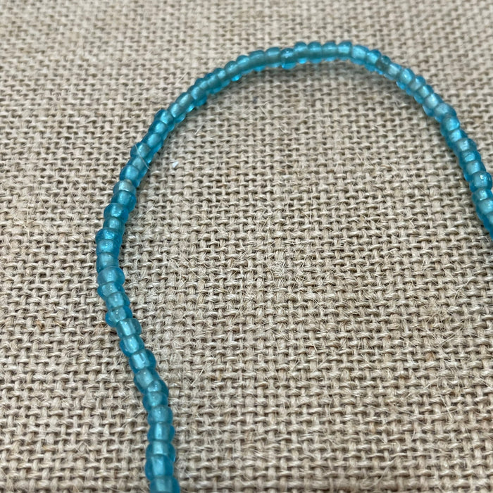 Raw string of beads necklace in blue showing rustic natural texture, coastal accessory