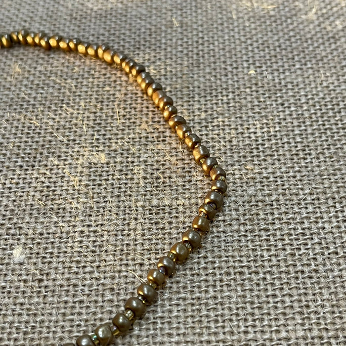 Bronze cowrie shell beaded necklace showing natural shells and beads, coastal accessory