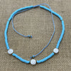 Blue shiva shell necklace featuring three shells on coloured cord, beach accessory