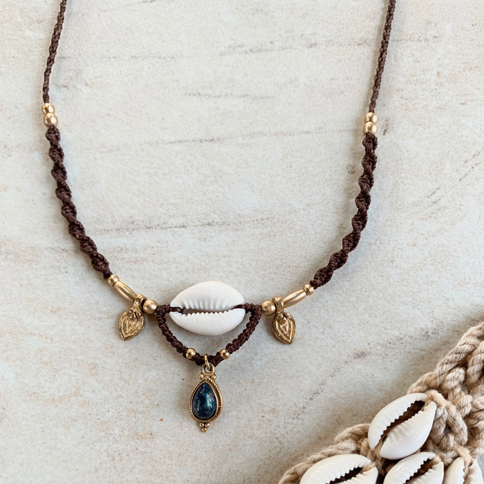 Cowrie and lapis lazuli necklace with natural shell and deep blue gemstone, handcrafted coastal bohemian jewelry