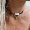 Cowrie macrame choker necklace with natural shell centerpiece and handcrafted knotwork, coastal bohemian jewelry
