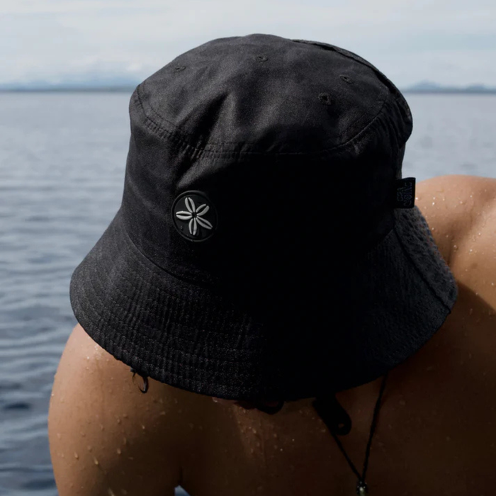 Person wearing Night Fish Ocean Hat while fishing on the water