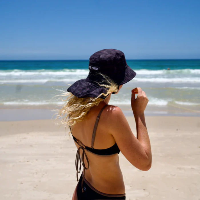 Person wearing Night Fish Ocean Hat while fishing on the water