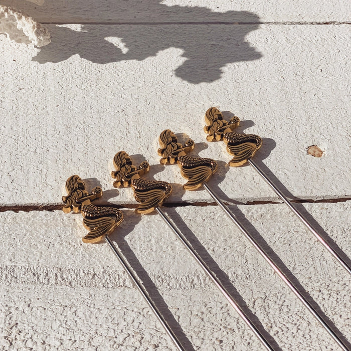 Coastal-style cocktail picks with detailed mermaid design