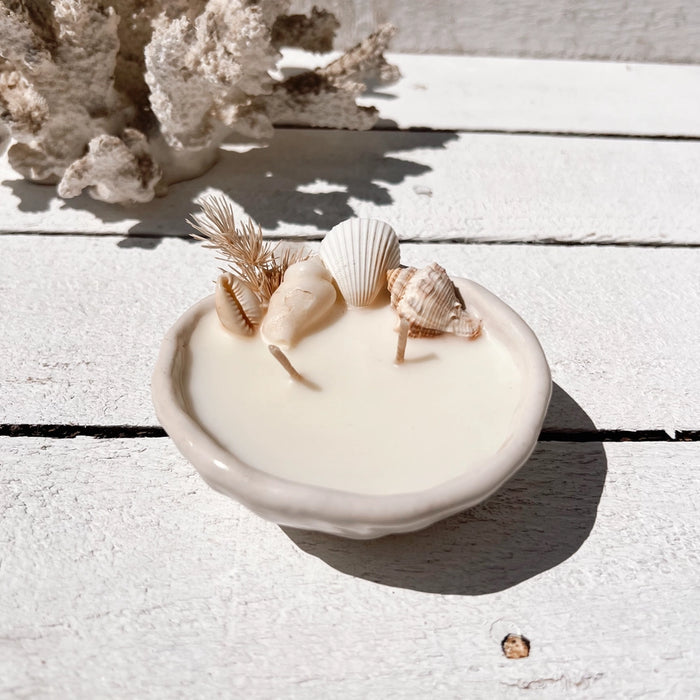 Seashell pinched ceramic candle with natural seashells and dried botanicals