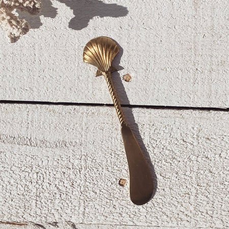 Brass seashell cheese knife styled for entertaining