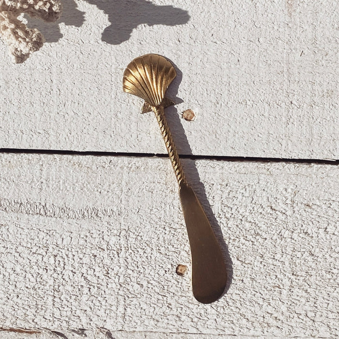 Brass seashell cheese knife styled for entertaining