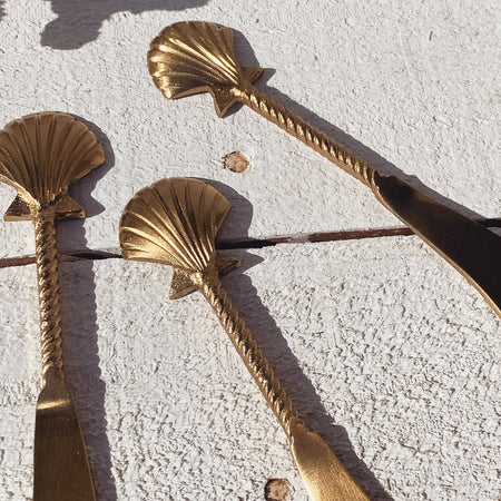 Brass seashell cheese knife styled for entertaining