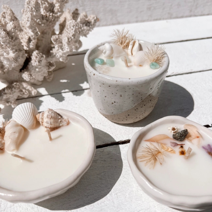 Seashell pinched ceramic candle with natural seashells and dried botanicals