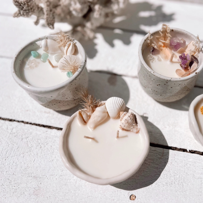 Seashell pinched ceramic candle with natural seashells and dried botanicals