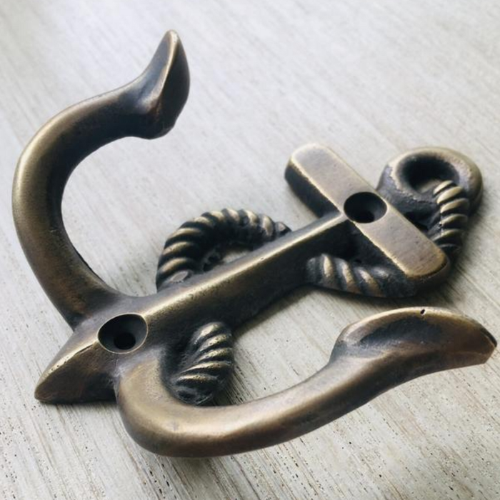 Nautical brass anchor hook mounted on wall