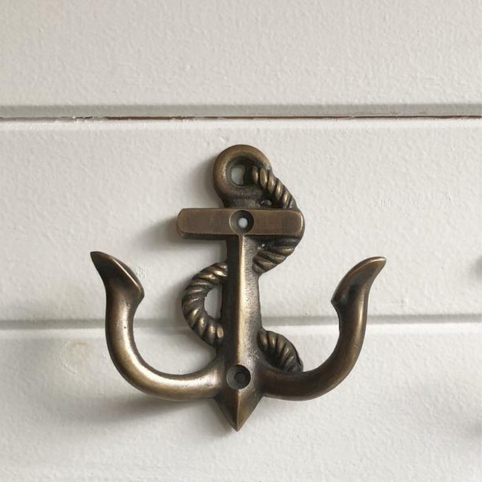 Nautical brass anchor hook mounted on wall