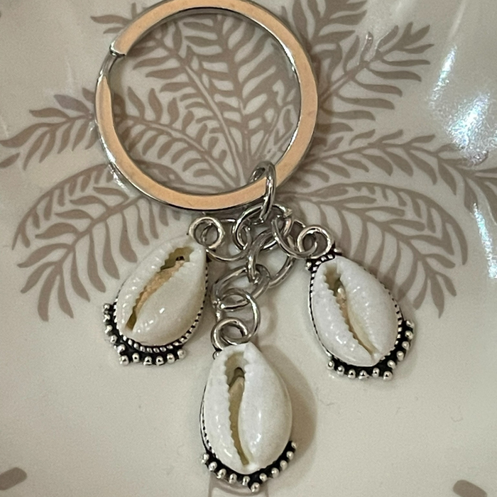 3 cowrie shell keyring with natural shells on detailed silver backing, 5cm coastal keychain