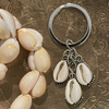 3 cowrie shell keyring with natural shells on detailed silver backing, 5cm coastal keychain