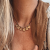 Close-up of brass beads and charm detail on bohemian necklace