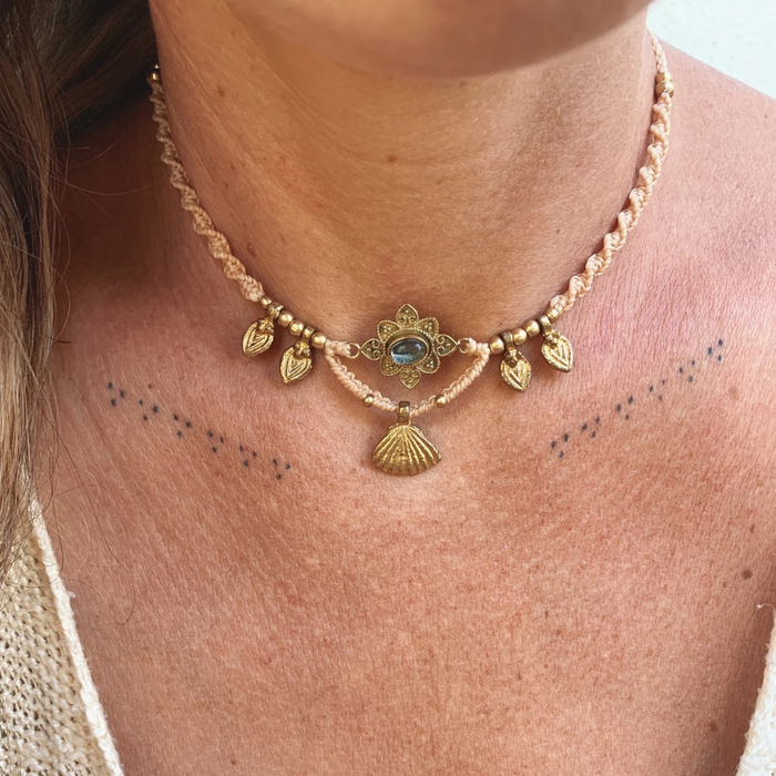 Handmade quartz macrame necklace with brass charms worn at adjustable length