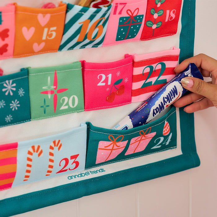 Fabric Advent Calendar with 24 numbered pockets, 39 × 58.5 cm, includes plastic tubing for easy hanging—ideal for daily Christmas treats.